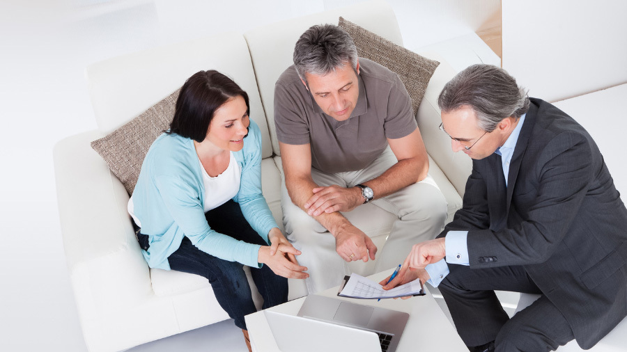 Seaside specialist speaking with clients about timeshare exit services for Holiday Concepts Group.