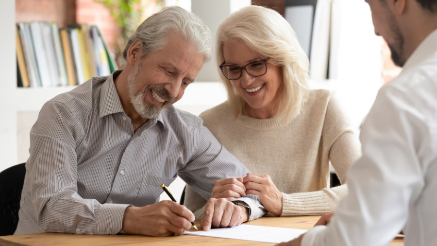Man and woman signing paperwork to cancel their St. Louis vacation ownership contract.